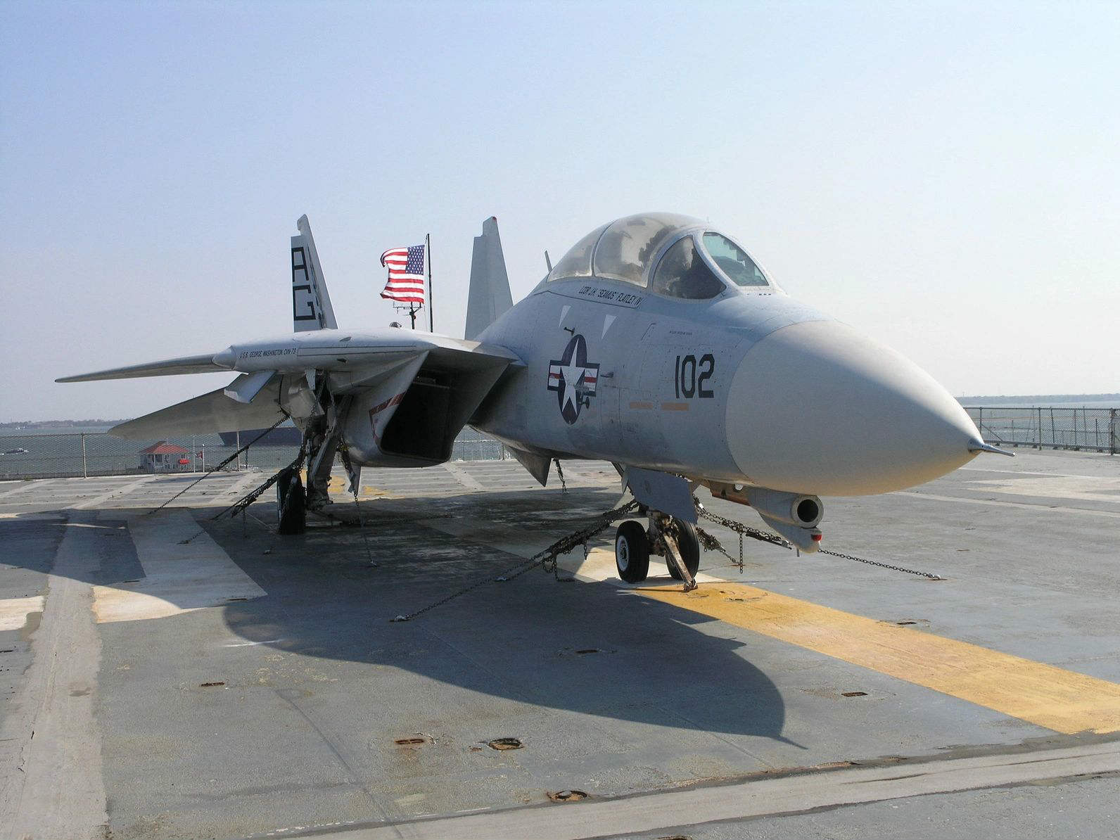 A fighter jet sitting on top of an airport runway.