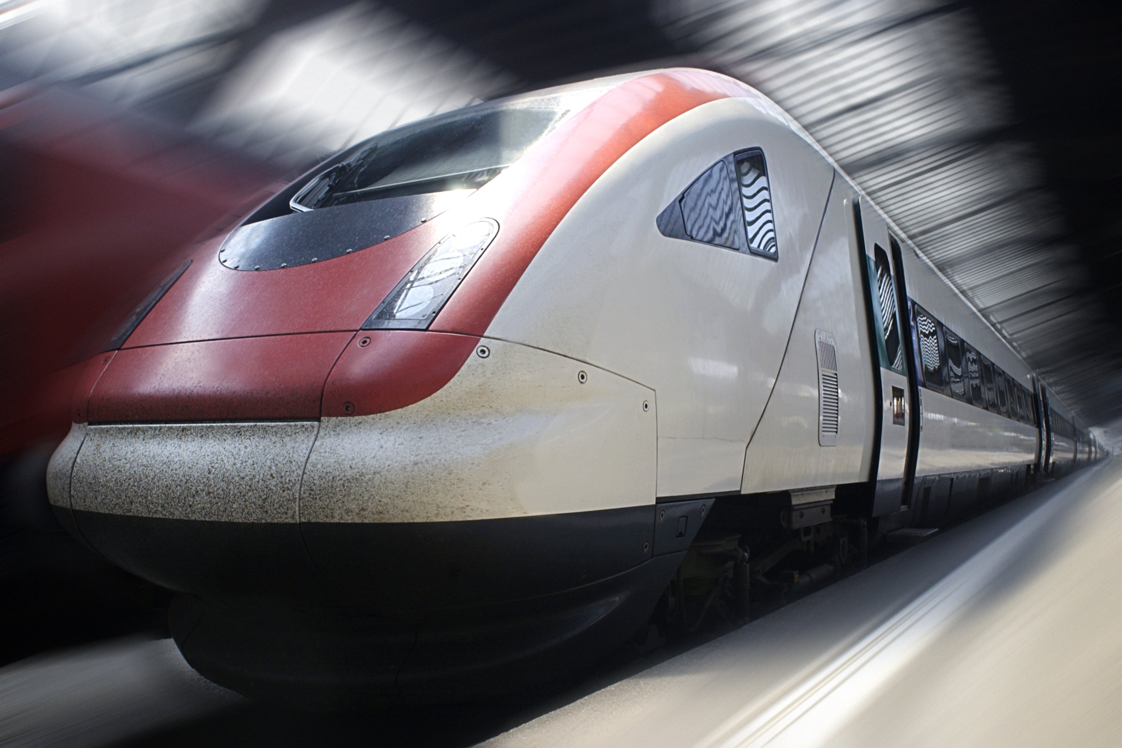 A train is traveling down the tracks in a station.
